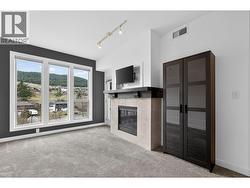 Bright And Modern Living Space With Large Windows, A Cozy Fireplace, And Plenty Of Natural Light - 