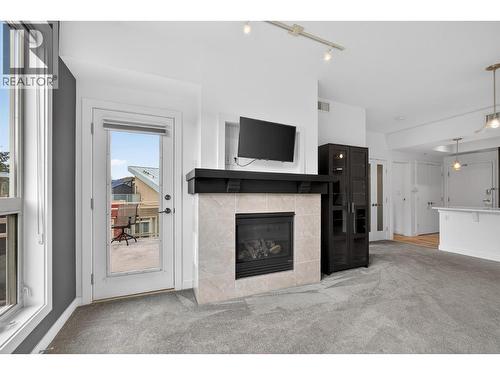7343 Okanagan Landing Road Unit# 2402, Vernon, BC - Indoor Photo Showing Living Room With Fireplace