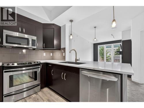 Modern, Renovated Kitchen With Sleek Finishes and Updated Appliances - 7343 Okanagan Landing Road Unit# 2402, Vernon, BC - Indoor Photo Showing Kitchen With Upgraded Kitchen