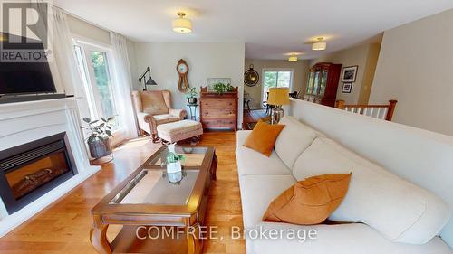 1680 Timmins Avenue, Innisfil (Alcona), ON - Indoor Photo Showing Living Room With Fireplace