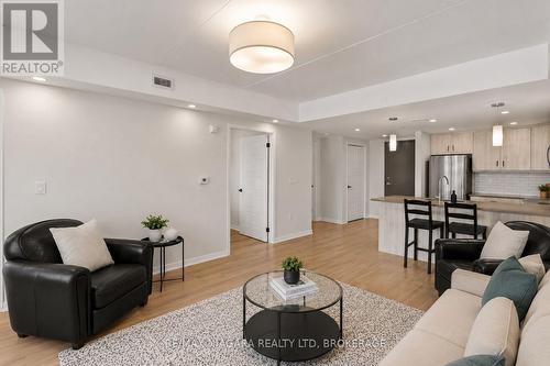 Virtually Staged - 206 - 3998 Victoria Avenue, Lincoln (Lincoln-Jordan/Vineland), ON - Indoor Photo Showing Living Room