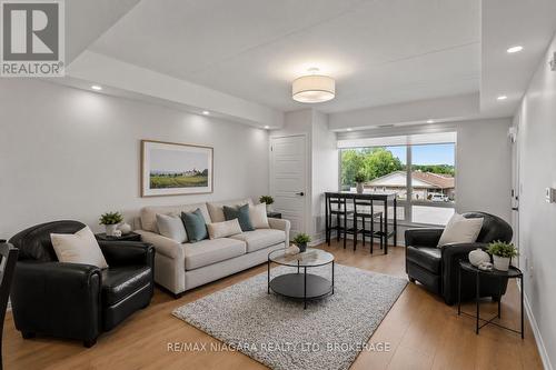 Virtually Staged - 206 - 3998 Victoria Avenue, Lincoln (Lincoln-Jordan/Vineland), ON - Indoor Photo Showing Living Room