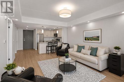 Virtually Staged - 206 - 3998 Victoria Avenue, Lincoln (Lincoln-Jordan/Vineland), ON - Indoor Photo Showing Living Room