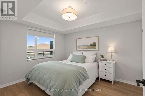 Virtually Staged - 206 - 3998 Victoria Avenue, Lincoln (Lincoln-Jordan/Vineland), ON - Indoor Photo Showing Bedroom