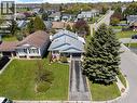 Residential property featuring a grey exterior and a dark asphalt driveway - 2 Hampton Court, Port Dover, ON  - Outdoor With View 