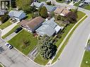 Residential property featuring a light-colored exterior, an attached garage, and a fenced backyard - 2 Hampton Court, Port Dover, ON  - Outdoor With View 