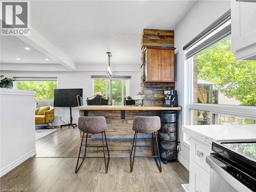 Kitchen island featuring wood-finish paneling, a light wood-finish countertop, and an integrated wood-finish cabinet - 209 Briarmeadow Drive, Kitchener, ON - Indoor Photo Showing Other Room