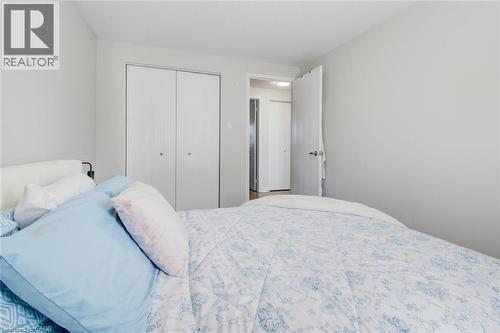 Neutral wall paint with white trim, featuring a bi-fold closet and a white door with dark hardware - 209 Briarmeadow Drive, Kitchener, ON - Indoor Photo Showing Bedroom