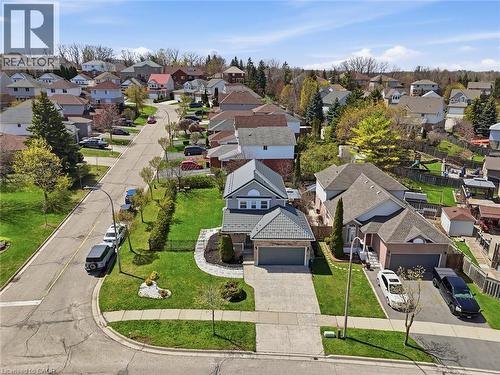 Two-story residence with a gray metal roof, attached two-car garage, concrete driveway, and front landscaping - 209 Briarmeadow Drive, Kitchener, ON - Outdoor With View