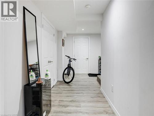 Hallway featuring wood-finish flooring, white doors, and recessed lighting - 209 Briarmeadow Drive, Kitchener, ON - Indoor Photo Showing Other Room