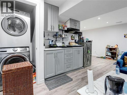 Compact kitchen area with light grey cabinetry, a stainless steel sink, and open shelving - 209 Briarmeadow Drive, Kitchener, ON - Indoor Photo Showing Laundry Room
