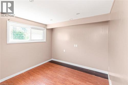 Room featuring wood-finish flooring, recessed ceiling lighting, and a white-framed window - 100 Mountain Avenue N, Hamilton, ON - Indoor Photo Showing Other Room