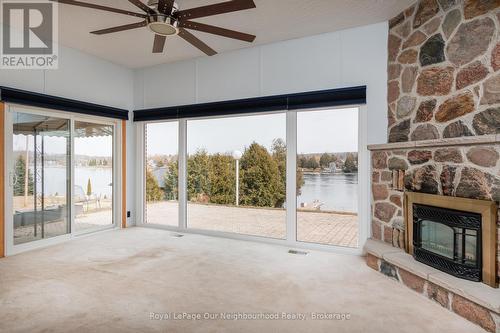 Panoramic south view of the Trent river - 18 Rosecliff Court, Trent Hills (Hastings), ON - Indoor Photo Showing Living Room With Fireplace