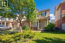 Light brick and neutral siding exterior with dark shutters, covered porch entry, mature front tree, and a manicured lawn - 5147 Ravine Crescent, Burlington, ON  - Outdoor 