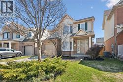 Two-story residential exterior featuring a brick and siding facade, a covered front porch, and a bay window - 