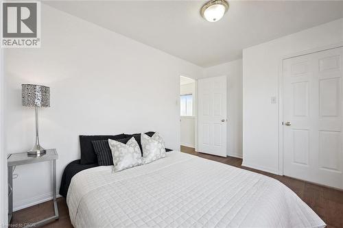 Bedroom featuring wood-finish flooring, white walls, and a flush mount ceiling light - 5147 Ravine Crescent, Burlington, ON - Indoor Photo Showing Bedroom