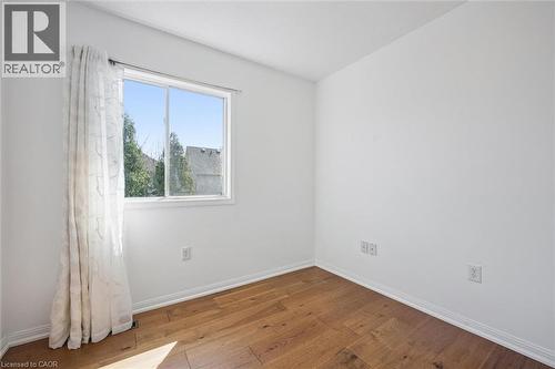 Bright room featuring wood-finish flooring and white walls - 5147 Ravine Crescent, Burlington, ON - Indoor Photo Showing Other Room
