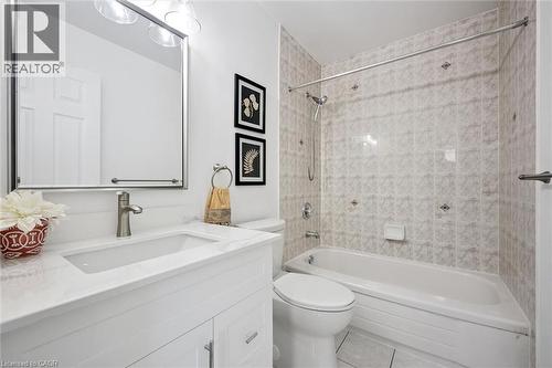 White vanity with an integrated rectangular sink, brushed nickel faucet, and a large mirrored medicine cabinet - 5147 Ravine Crescent, Burlington, ON - Indoor Photo Showing Bathroom
