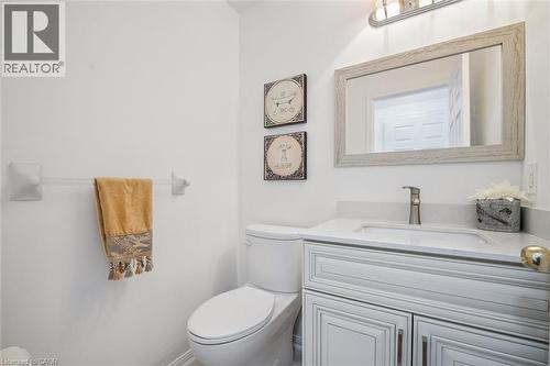 White vanity with shaker-style cabinetry, an undermount sink, and a quartz countertop - 5147 Ravine Crescent, Burlington, ON - Indoor Photo Showing Bathroom