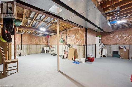 Unfinished basement featuring exposed joist ceiling, concrete foundation walls, painted concrete flooring, and visible ductwork - 5147 Ravine Crescent, Burlington, ON - Indoor Photo Showing Basement