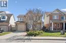 Two-story residence featuring a brick and siding exterior, an attached garage, and a paved driveway - 5147 Ravine Crescent, Burlington, ON  - Outdoor With Facade 