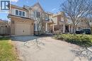 Two-story residence featuring a brick and siding exterior, an attached single-car garage, and a covered front porch with white railings - 5147 Ravine Crescent, Burlington, ON  - Outdoor With Facade 