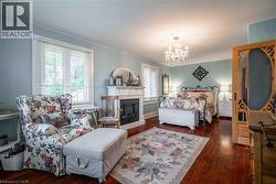 Oversized elegant Primary bedroom features hardwood floors - 