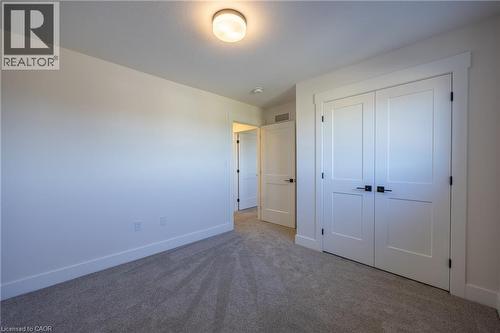 Neutral wall color palette with bright white trim and soft gray carpeting - 111 Amber Street, Waterford, ON - Indoor Photo Showing Other Room