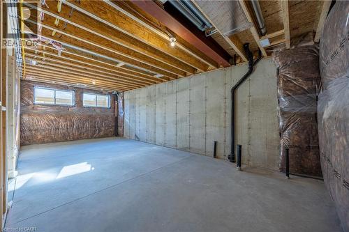 Unfinished basement space featuring exposed wood joists, concrete flooring, and multiple windows - 111 Amber Street, Waterford, ON - Indoor Photo Showing Basement