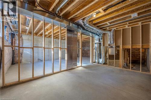 Unfinished basement featuring wood framing, exposed ceiling joists, concrete flooring, and visible ductwork - 111 Amber Street, Waterford, ON - Indoor Photo Showing Basement