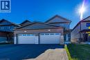 Contemporary residence featuring a brick and siding exterior with stone accents, a two-car garage with transom windows, and an asphalt driveway - 115 Amber Street, Waterford, ON  - Outdoor With Facade 