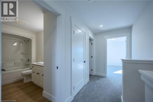 Full bathroom featuring a single white vanity with a rectangular sink, a toilet, and a combined shower and tub with a white surround - 115 Amber Street, Waterford, ON - Indoor Photo Showing Bathroom
