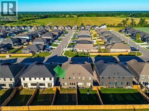 Contemporary residential development featuring a structured street layout, uniform housing designs, and distinct backyard spaces - 115 Amber Street, Waterford, ON - Outdoor With View