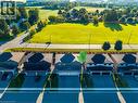 Detached property featuring a two-car garage, dark shingled roof, and light-colored siding - 115 Amber Street, Waterford, ON  -  With View 
