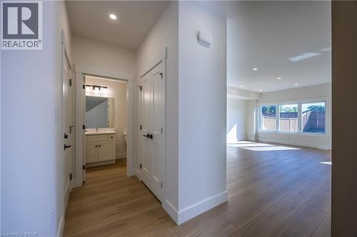 Spacious interior featuring wood-finish flooring, recessed lighting, and a neutral color palette - 115 Amber Street, Waterford, ON - Indoor Photo Showing Other Room
