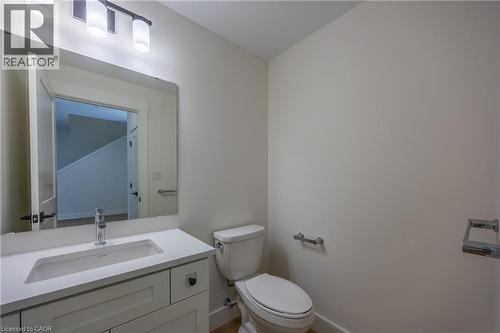 Bathroom vanity featuring a white rectangular undermount sink, a chrome single-handle faucet, and a light-toned countertop - 115 Amber Street, Waterford, ON - Indoor Photo Showing Bathroom