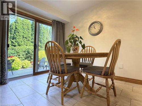 Eat in kitchen with sliding glass doors provide access to a private exterior space with mature trees and shrubbery - 7 Mann Avenue, Simcoe, ON - Indoor Photo Showing Dining Room