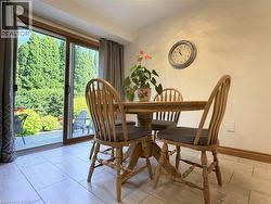 Eat in kitchen with sliding glass doors provide access to a private exterior space with mature trees and shrubbery - 