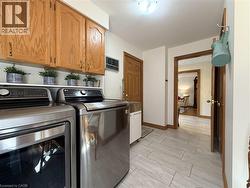 Main floor laundry with double closet and access to both the garage and patio on the side of the home. - 