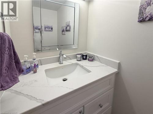 Main floor powder room with quartz counter. - 7 Mann Avenue, Simcoe, ON - Indoor Photo Showing Bathroom