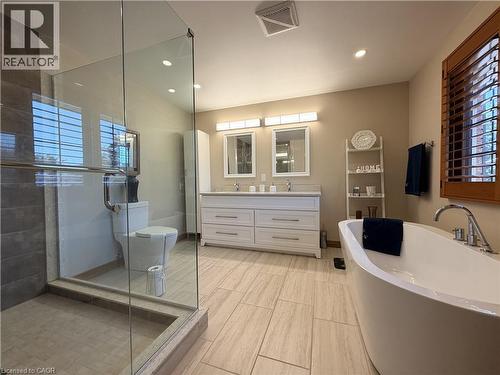 Luxurious spa-inspired ensuite complete with a freestanding soaker tub, double vanity and glass walk-in shower. - 7 Mann Avenue, Simcoe, ON - Indoor Photo Showing Bathroom