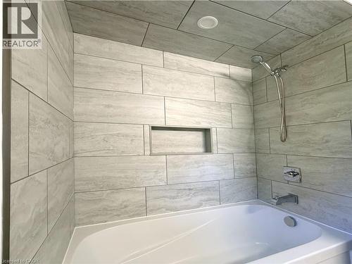 Fully tiled tub/shower combo. - 7 Mann Avenue, Simcoe, ON - Indoor Photo Showing Bathroom