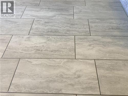 New flooring throughout oversize tiles.Solid wood interior doors, central vacuum, custom window coverings including California shutters, and quality finishes throughout reflect the pride of ownership - 7 Mann Avenue, Simcoe, ON - 