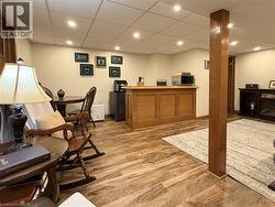 Basement games room with bar, new drop ceiling panels and pot lights. - 