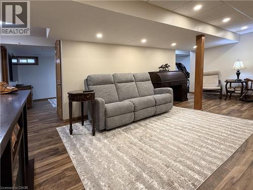 Game room features an electric fireplace and a bar. - 7 Mann Avenue, Simcoe, ON - Indoor