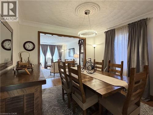 Formal Dining Room features hardwood flooring, new lighting and has an entrance to the eat in kitchen. - 7 Mann Avenue, Simcoe, ON - Indoor Photo Showing Dining Room