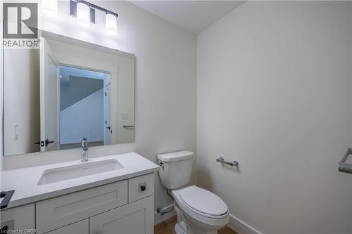 Bathroom featuring a white vanity with an undermount sink, a chrome faucet, and a large wall-mounted mirror - 107 Amber Street, Waterford, ON - Indoor Photo Showing Bathroom