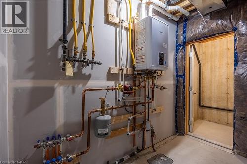 Utility room featuring a tankless water heater, copper piping, and gas lines - 107 Amber Street, Waterford, ON - Indoor Photo Showing Basement