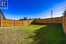 Expansive backyard featuring a new perimeter wood fence, a large grass area, and a gradual slope - 107 Amber Street, Waterford, ON  - Outdoor 