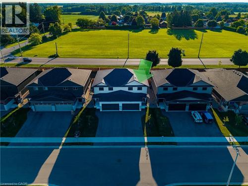 Modern two-story residence featuring a dark-toned facade, a contrasting light-toned upper level, and a prominent double garage - 107 Amber Street, Waterford, ON - Outdoor